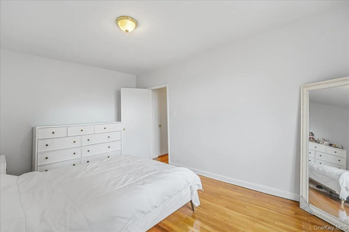 Bedroom with light wood-type flooring and baseboards Bedroom with light wood-type flooring and baseboards