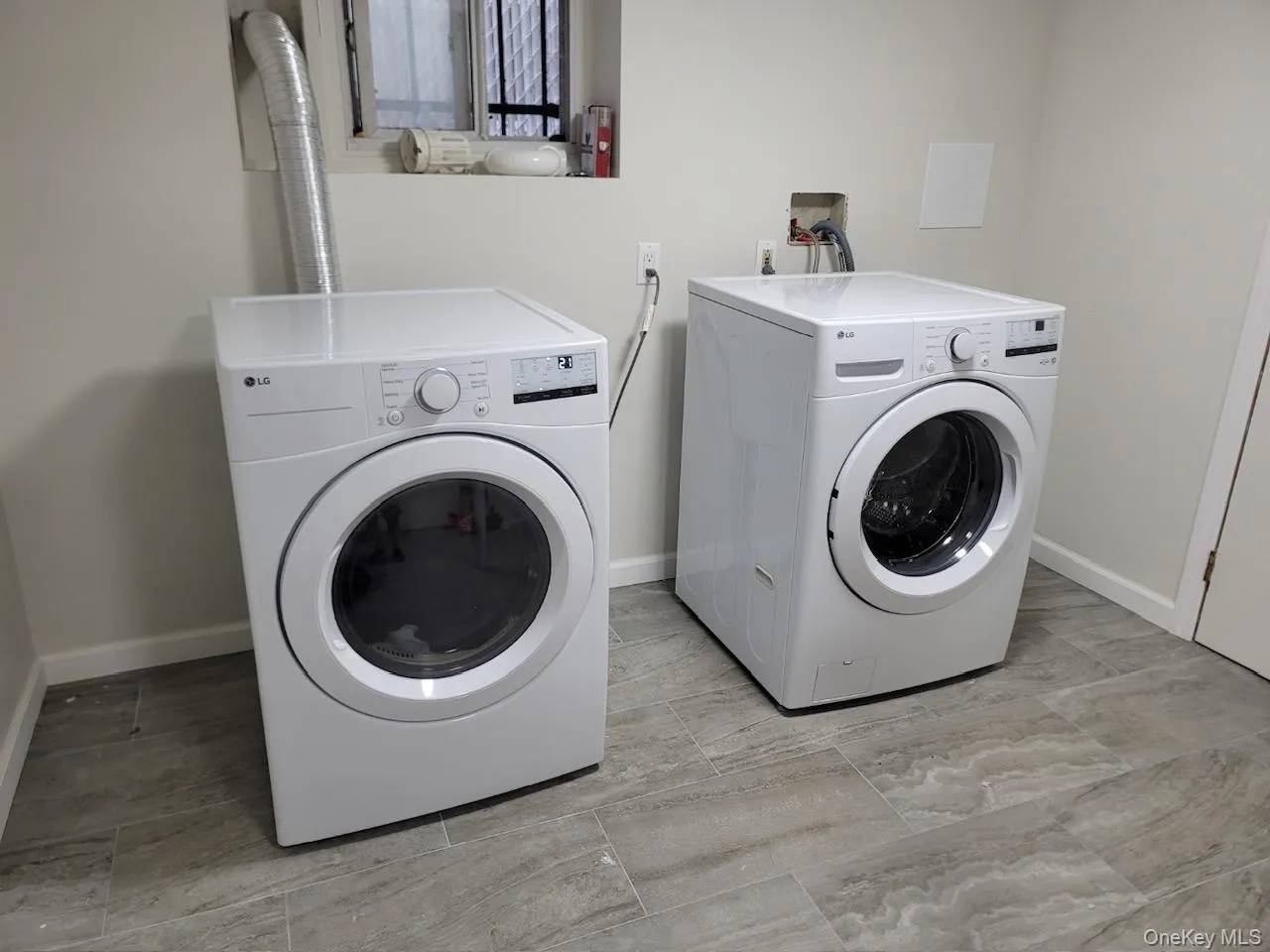 Laundry room with washer and dryer and baseboards Laundry room with washer and dryer and baseboards
