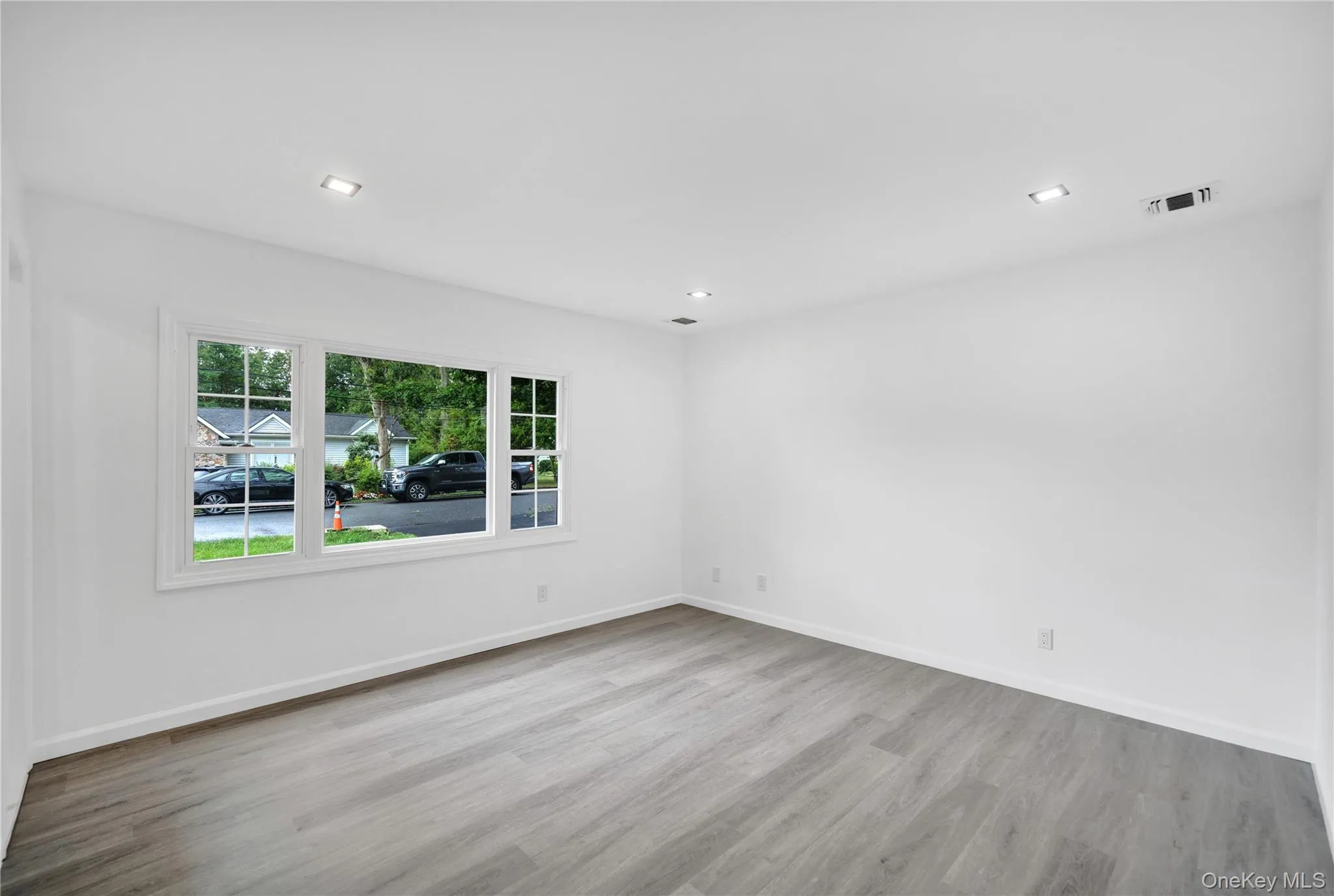 Unfurnished room with light wood finished floors and recessed lighting Unfurnished room with light wood finished floors and recessed lighting