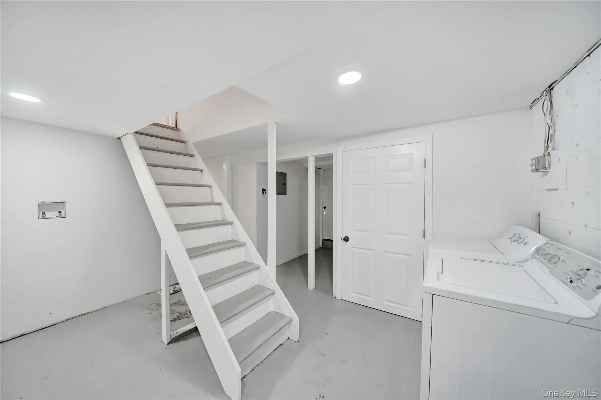 Finished basement featuring stairway and washer and dryer Finished basement featuring stairway and washer and dryer