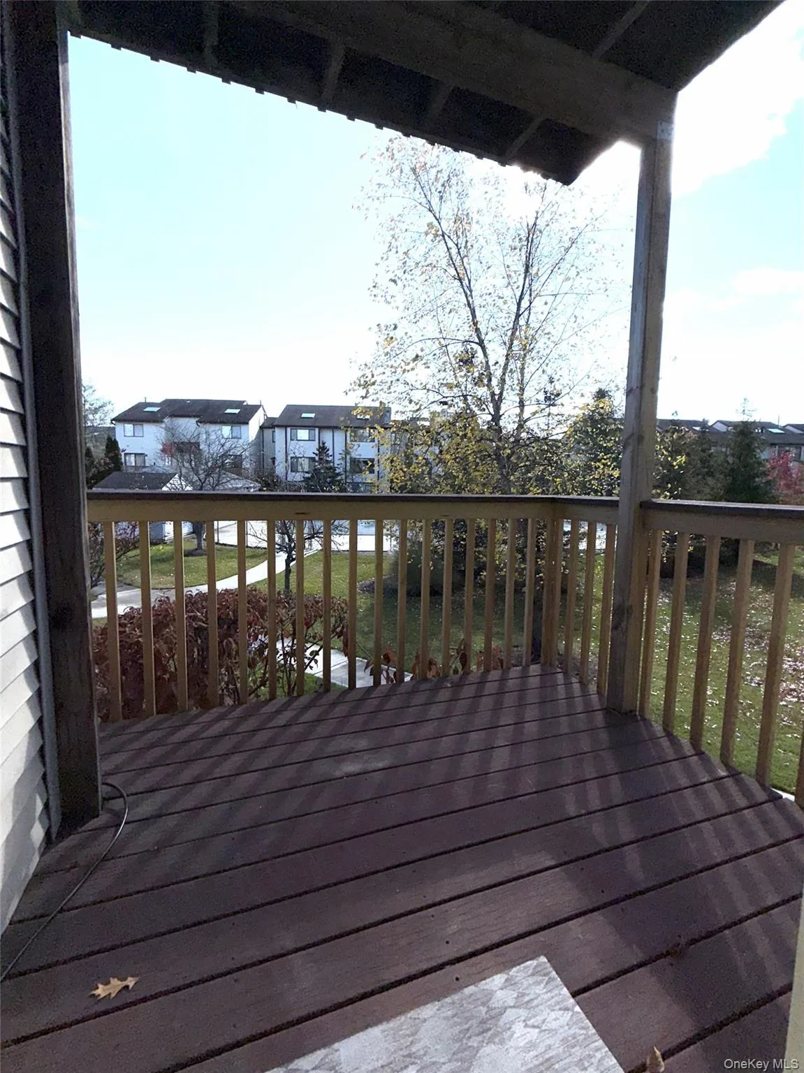 Wooden terrace featuring a yard Wooden terrace featuring a yard