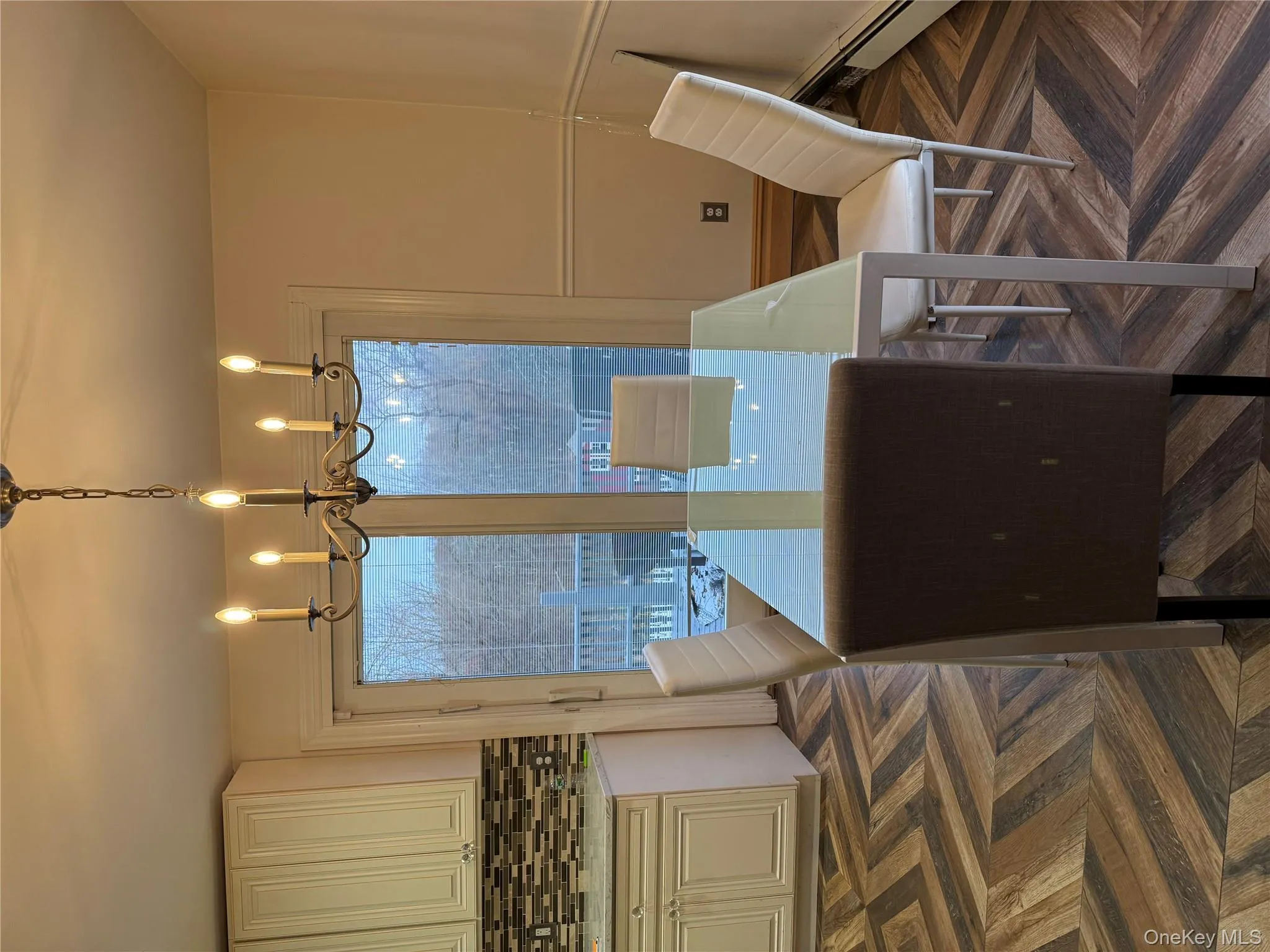 Dining space featuring a baseboard radiator and a chandelier Dining space featuring a baseboard radiator and a chandelier