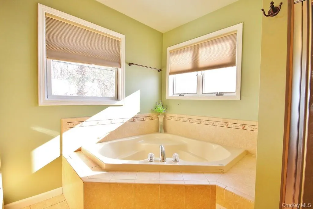 Full bathroom featuring a bath Full bathroom featuring a bath