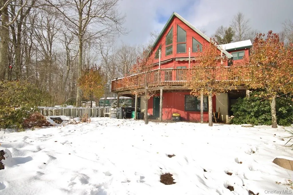 Snow covered property featuring a wooden deck Snow covered property featuring a wooden deck