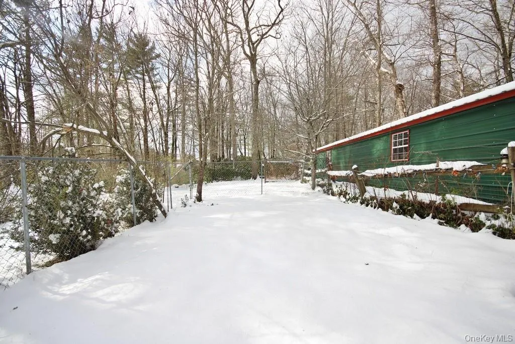 View of yard covered in snow View of yard covered in snow