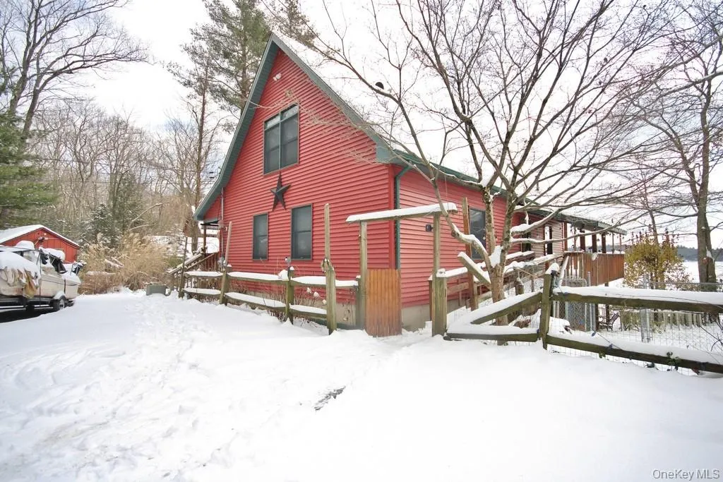 Snow covered property featuring a deck Snow covered property featuring a deck