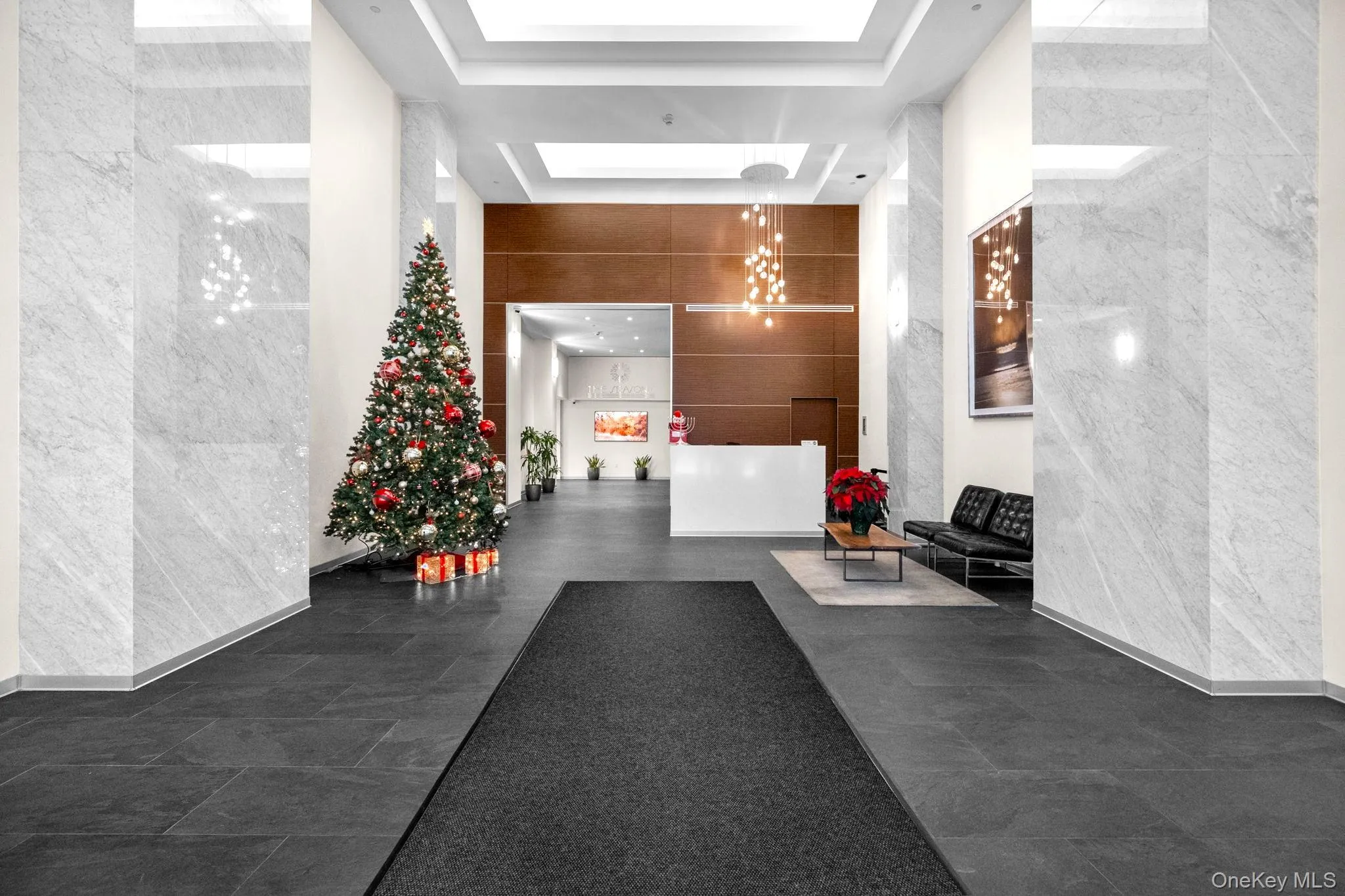 Building lobby with a high ceiling and tile walls Building lobby with a high ceiling and tile walls