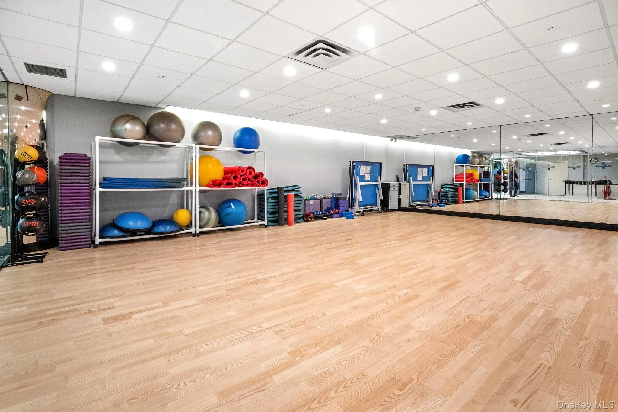Exercise room with a drop ceiling and recessed lighting Exercise room with a drop ceiling and recessed lighting