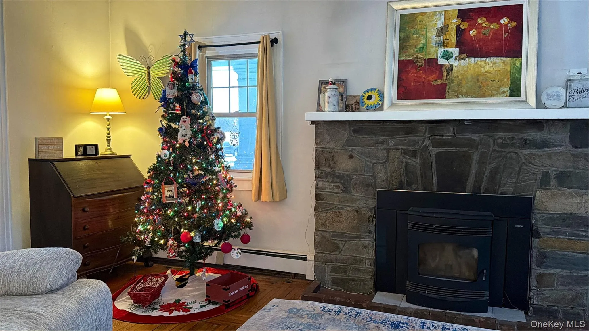 Living room with a wood stove and a baseboard radiator Living room with a wood stove and a baseboard radiator
