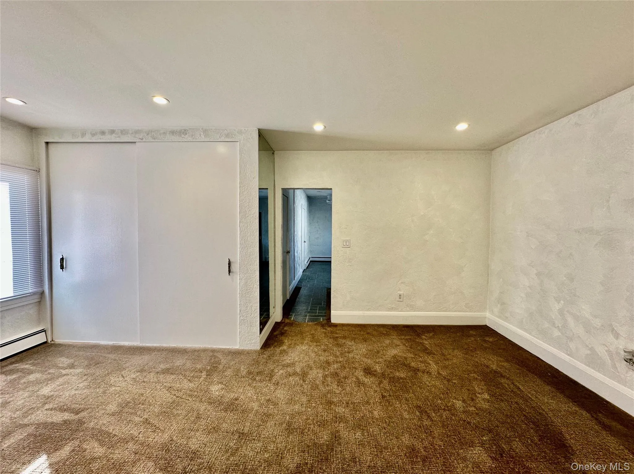 Spare room with dark carpet and recessed lighting Spare room with dark carpet and recessed lighting