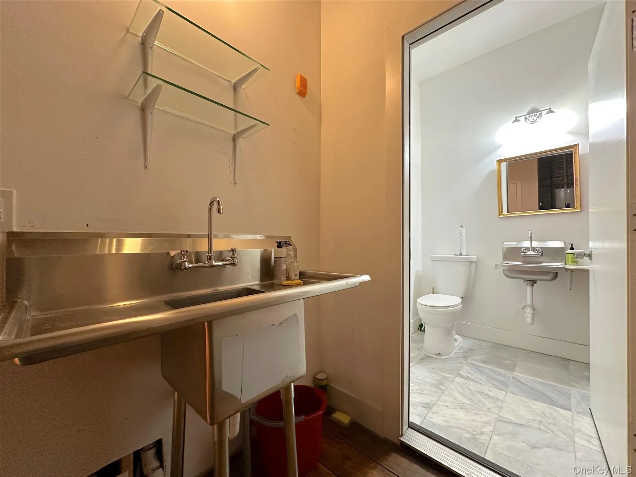 Half bathroom featuring toilet and baseboards Half bathroom featuring toilet and baseboards