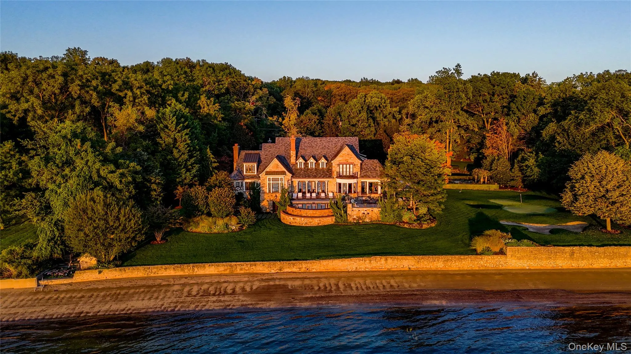 Aerial view of property and surrounding area with a nearby body of water Aerial view of property and surrounding area with a nearby body of water