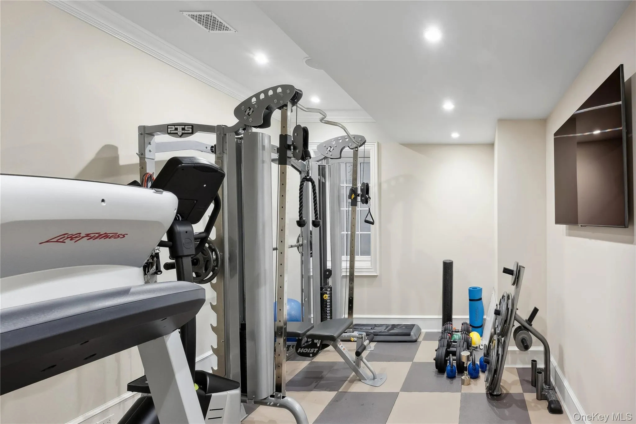 Workout room featuring light flooring, recessed lighting, and ornamental molding Workout room featuring light flooring, recessed lighting, and ornamental molding