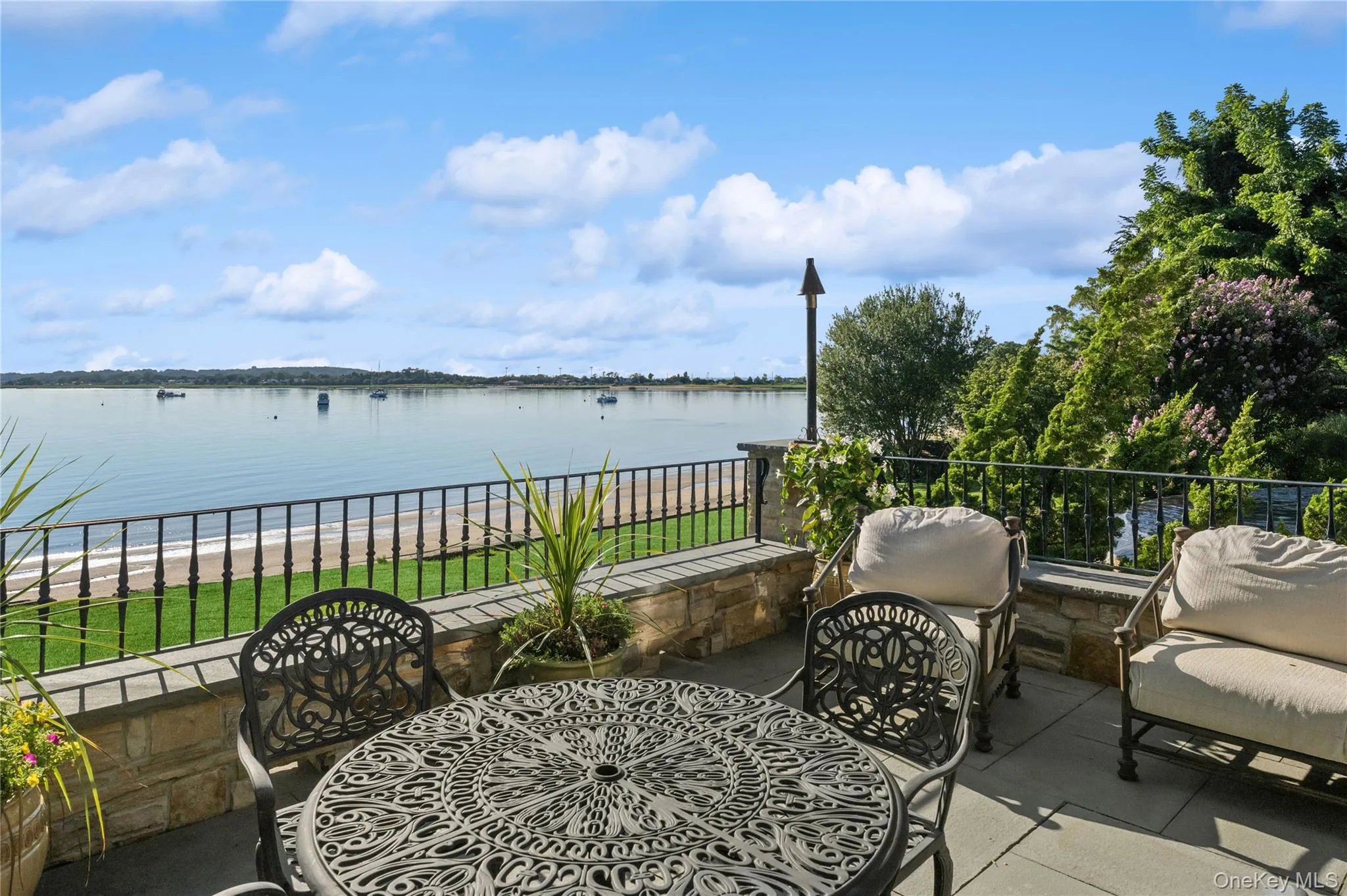 View of patio featuring a water view and outdoor dining area View of patio featuring a water view and outdoor dining area