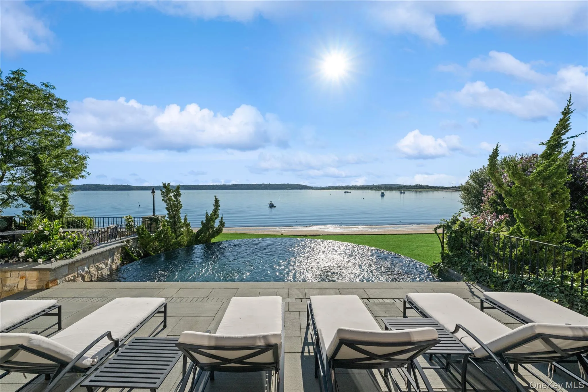 View of pool featuring a water view and an infinity pool View of pool featuring a water view and an infinity pool