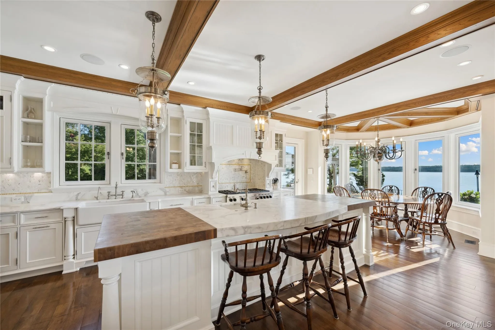 Kitchen featuring white cabinetry, pendant lighting, butcher block counters, plenty of natural light, and beam ceiling Kitchen featuring white cabinetry, pendant lighting, butcher block counters, plenty of natural light, and beam ceiling