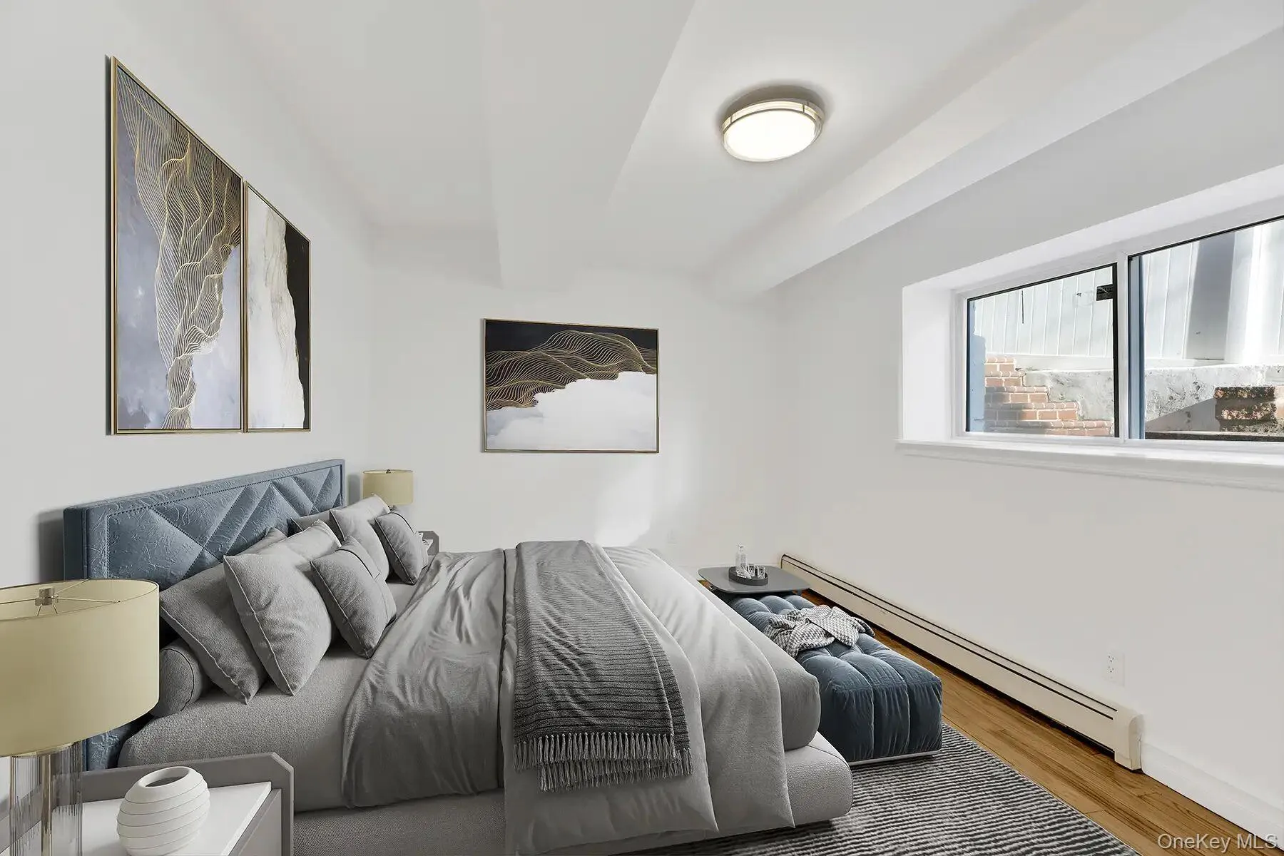 Bedroom featuring a baseboard radiator and wood finished floors Bedroom featuring a baseboard radiator and wood finished floors