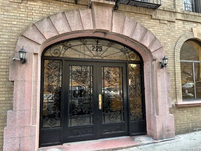 Property entrance with brick siding and french doors Property entrance with brick siding and french doors