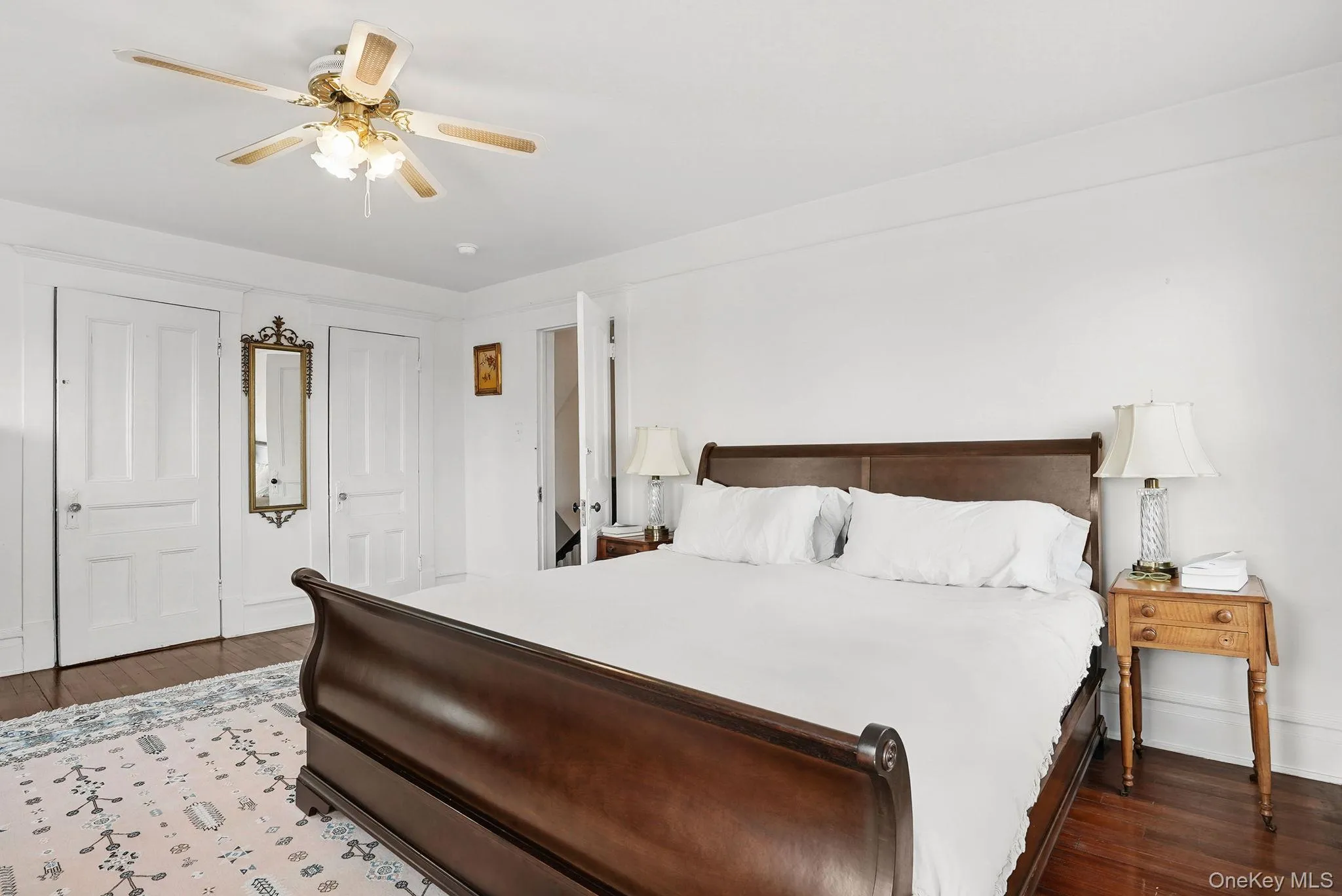 Corner primary bedroom with hardwood floors Corner primary bedroom with hardwood floors