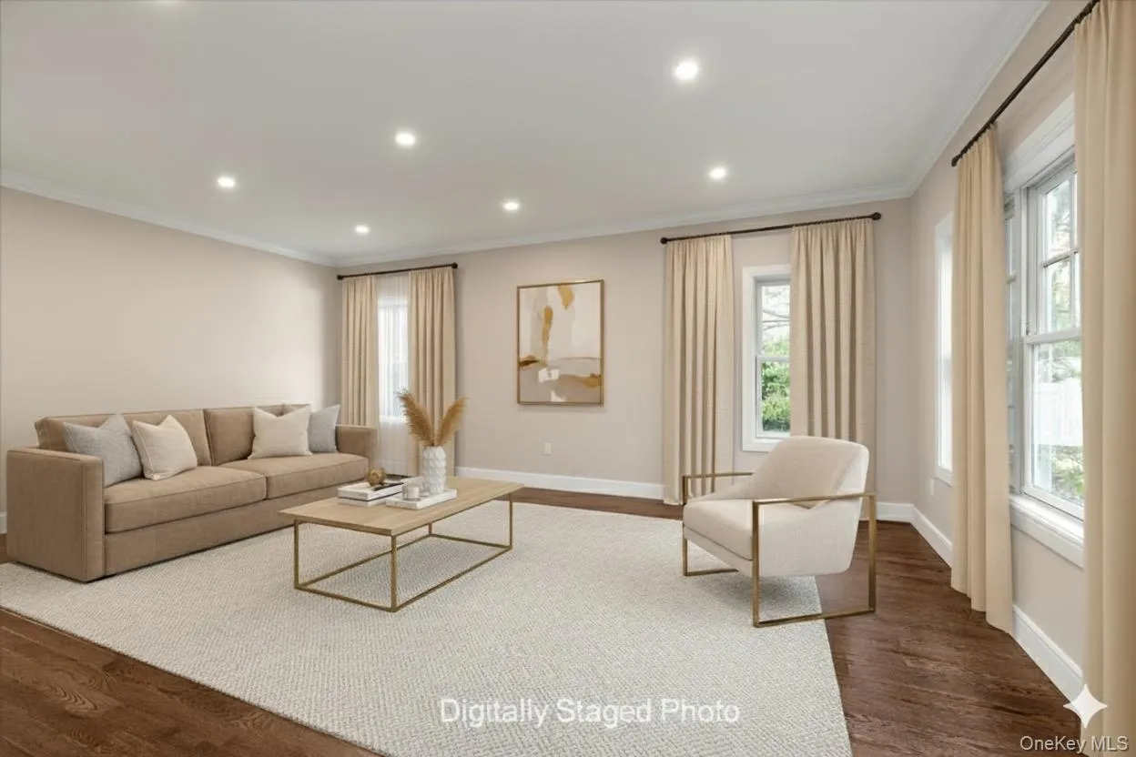 Living area featuring dark wood finished floors, ornamental molding, recessed lighting, and plenty of natural light Living area featuring dark wood finished floors, ornamental molding, recessed lighting, and plenty of natural light