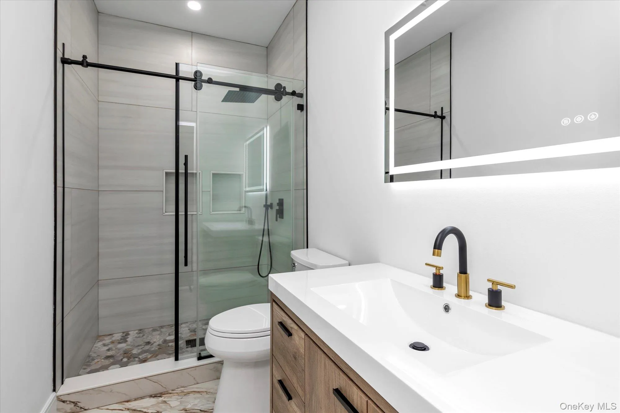 Bathroom with vanity, a stall shower, and light marble finish flooring Bathroom with vanity, a stall shower, and light marble finish flooring