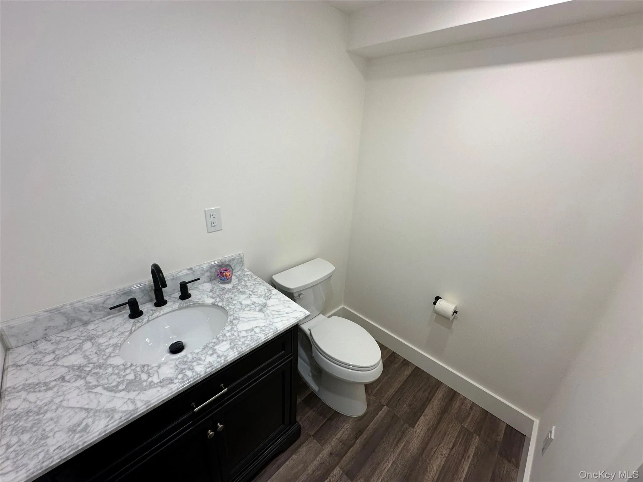 Bathroom with vanity and dark wood-type flooring Bathroom with vanity and dark wood-type flooring