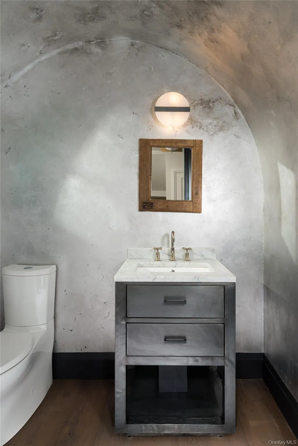 Half bath featuring vanity and dark wood-type flooring Half bath featuring vanity and dark wood-type flooring