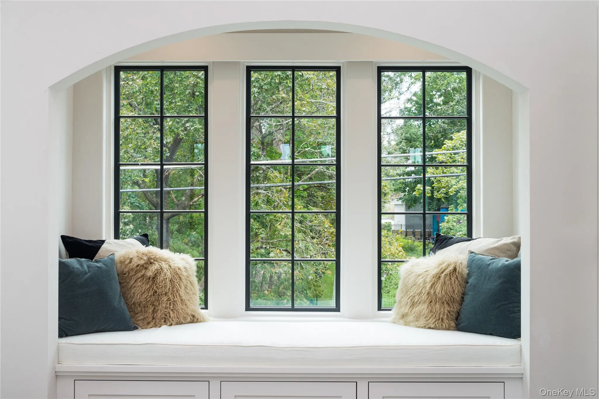Doorway to outside with arched walkways and healthy amount of natural light Doorway to outside with arched walkways and healthy amount of natural light