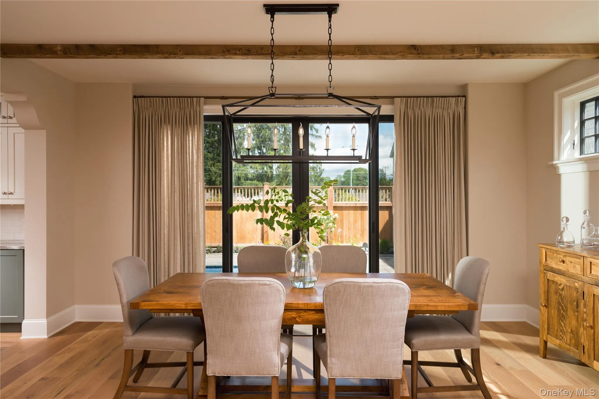 Dining space featuring light wood finished floors, beamed ceiling, and healthy amount of natural light Dining space featuring light wood finished floors, beamed ceiling, and healthy amount of natural light