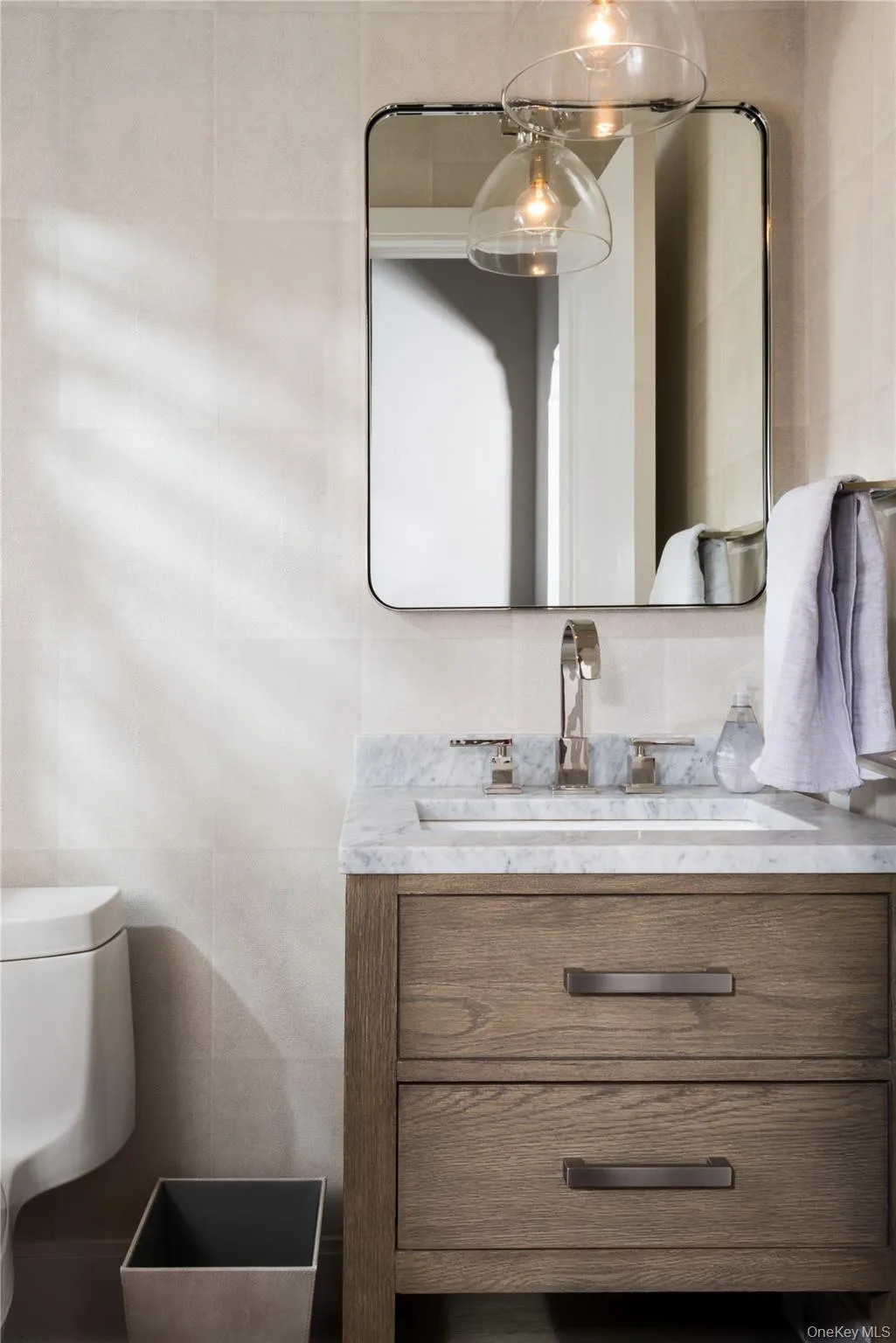Bathroom featuring tile walls and vanity Bathroom featuring tile walls and vanity