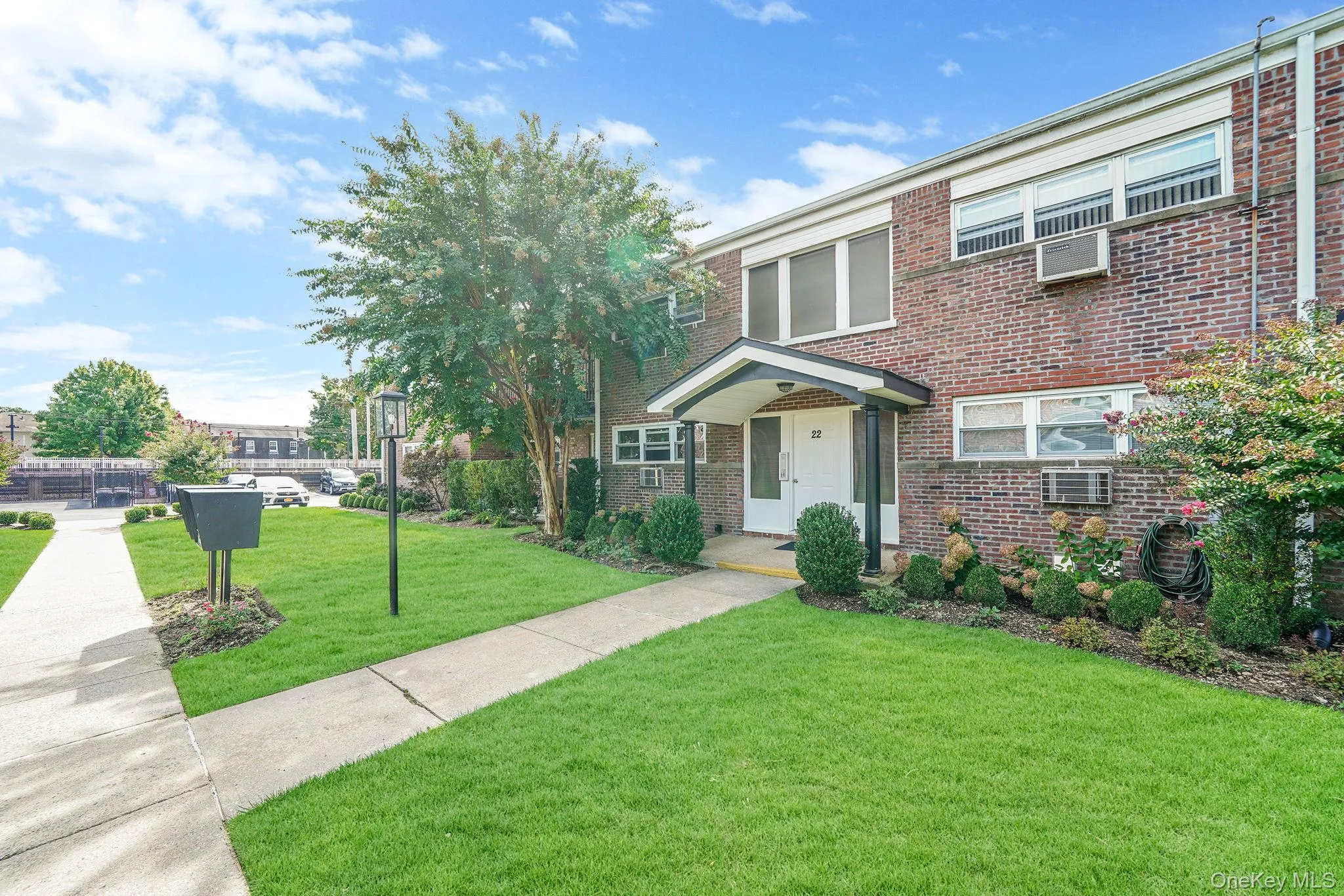 Traditional home featuring a front lawn and brick siding Traditional home featuring a front lawn and brick siding