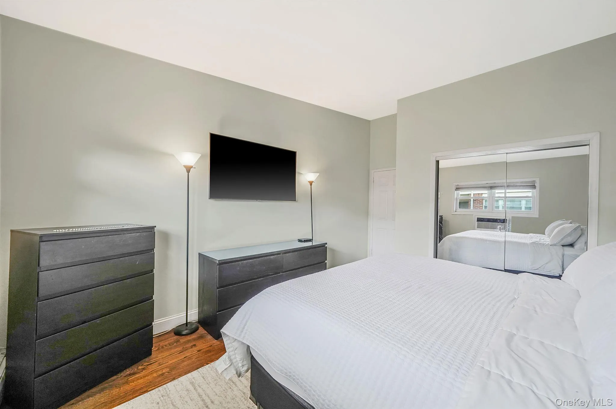 Bedroom with wood finished floors and a closet Bedroom with wood finished floors and a closet