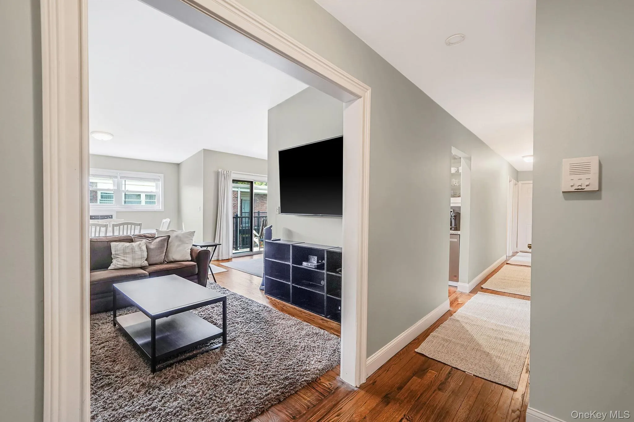 Living room with hardwood / wood-style flooring and baseboards Living room with hardwood / wood-style flooring and baseboards