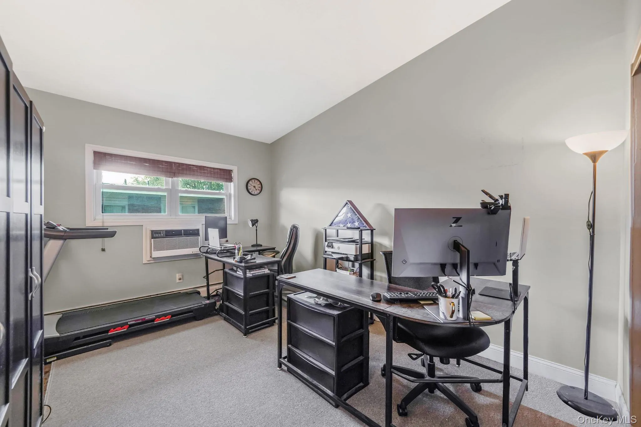 Office with light colored carpet and lofted ceiling Office with light colored carpet and lofted ceiling