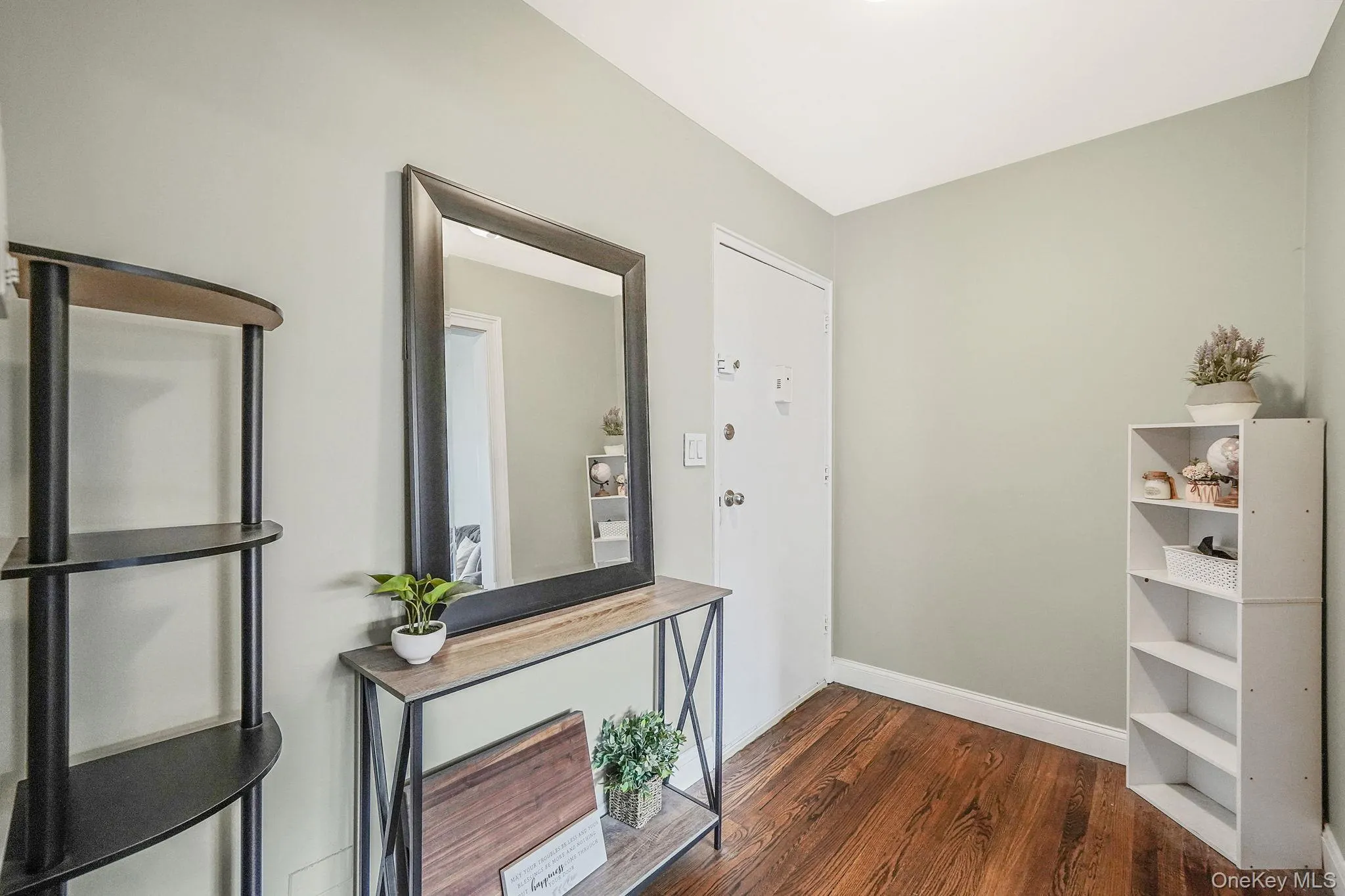 Hall featuring dark wood-style flooring and baseboards Hall featuring dark wood-style flooring and baseboards