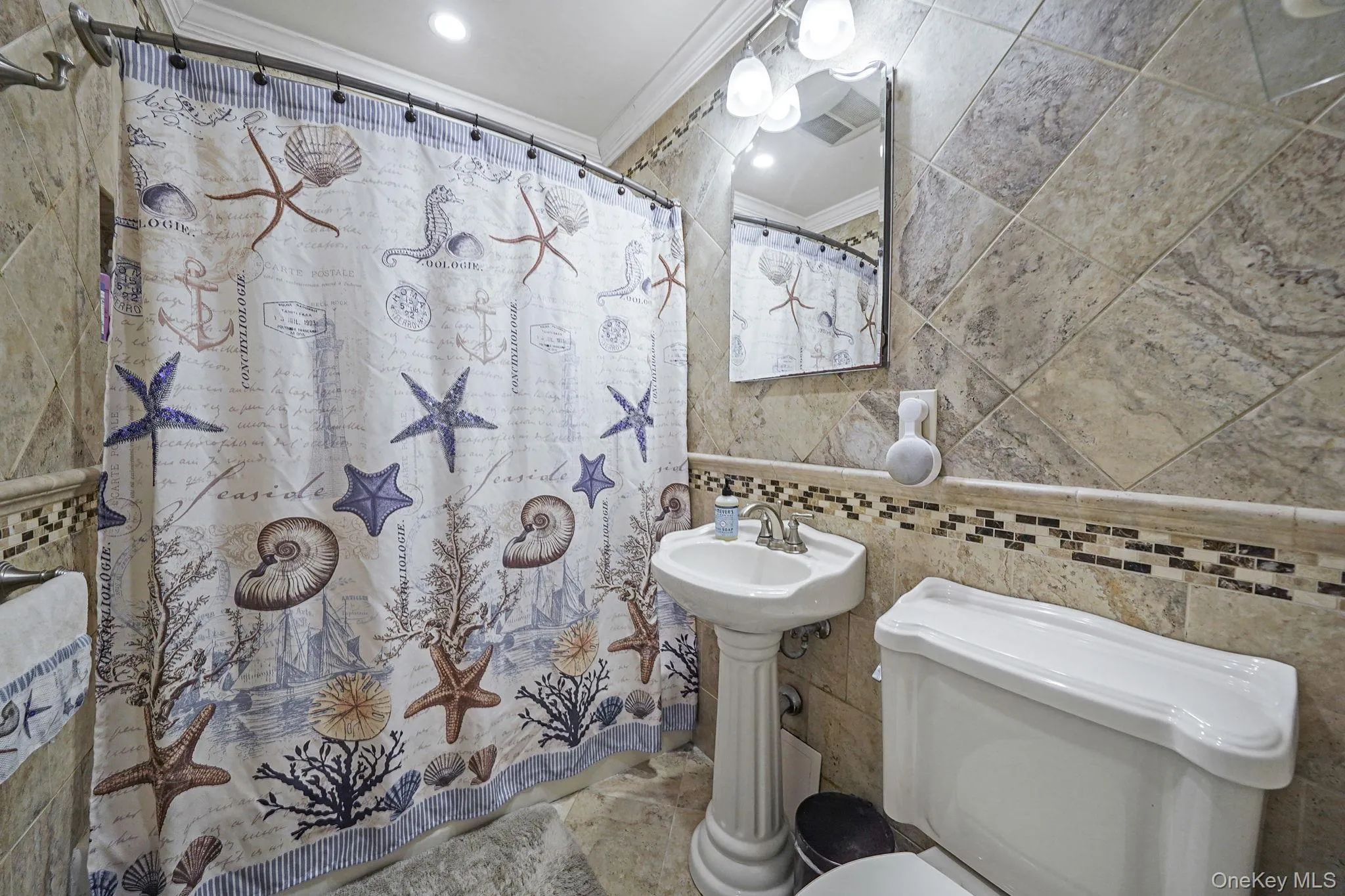 Bathroom featuring tile walls, crown molding, a shower with curtain, and recessed lighting Bathroom featuring tile walls, crown molding, a shower with curtain, and recessed lighting