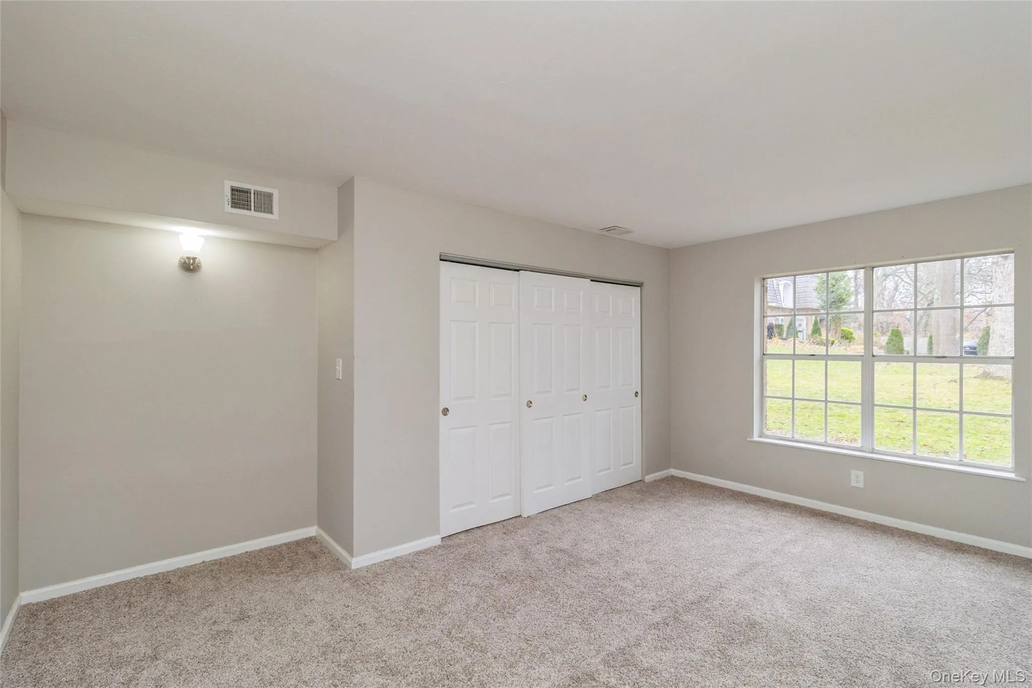 Unfurnished bedroom with carpet and a closet Unfurnished bedroom with carpet and a closet