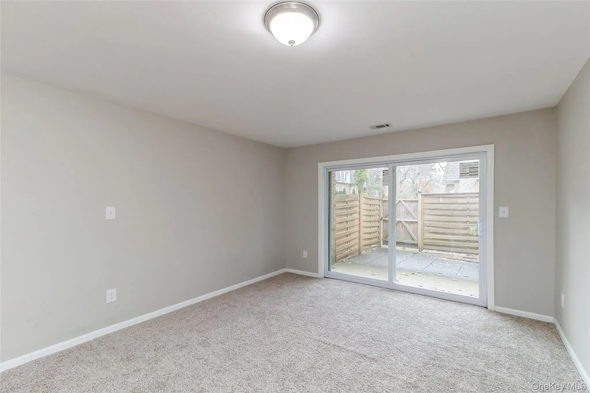 Spare room featuring light carpet and baseboards Spare room featuring light carpet and baseboards
