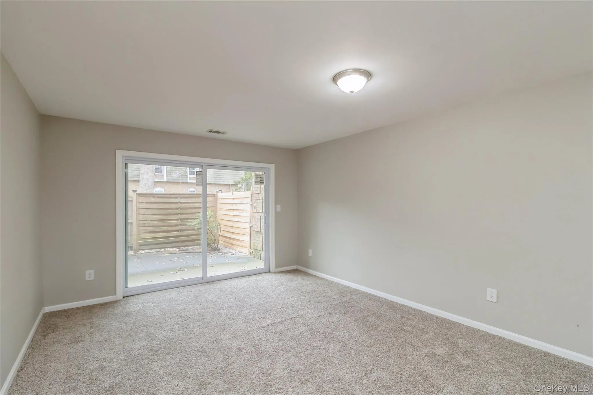 Spare room featuring light carpet and baseboards Spare room featuring light carpet and baseboards