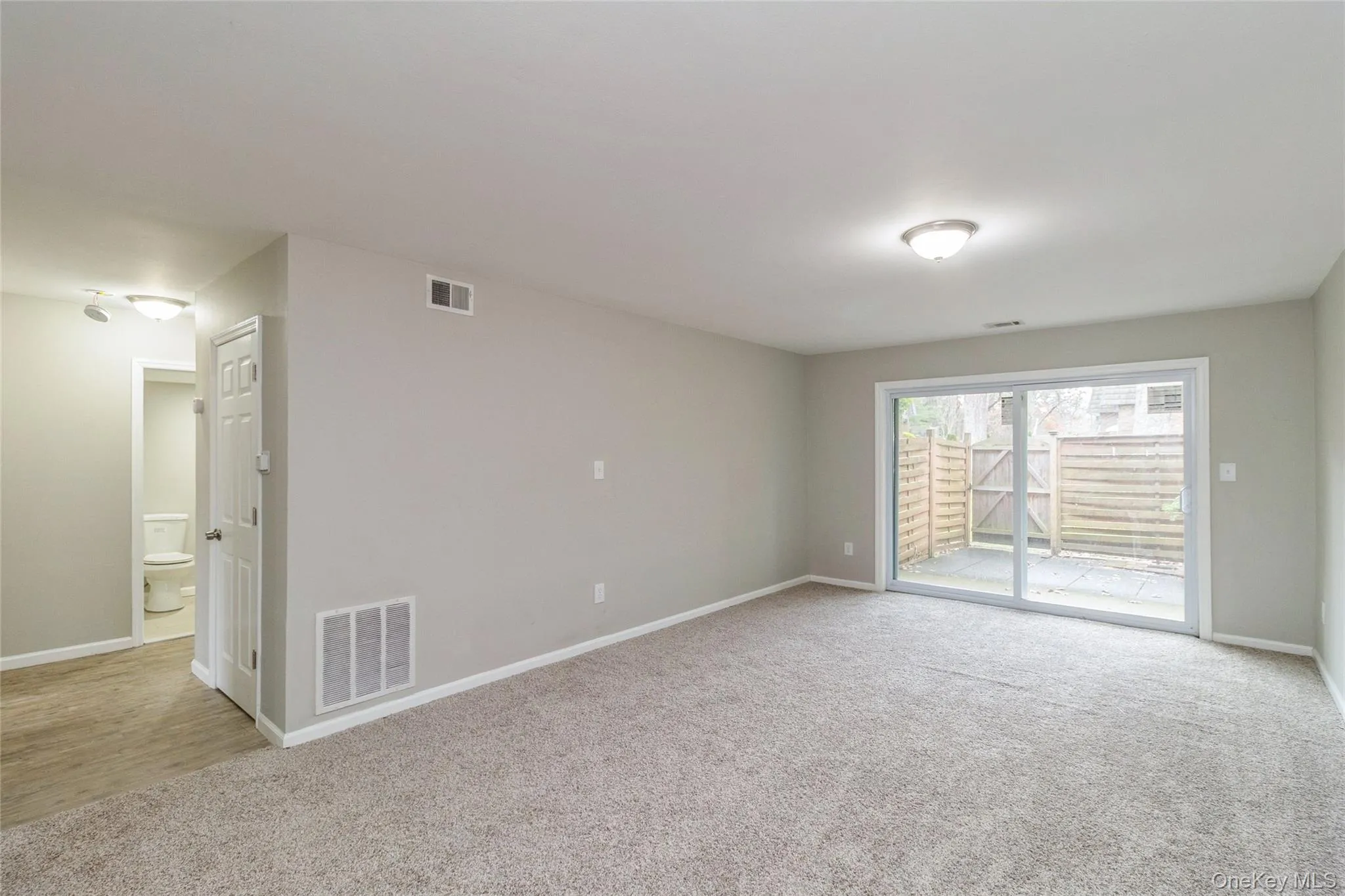 Unfurnished room featuring light carpet and baseboards Unfurnished room featuring light carpet and baseboards
