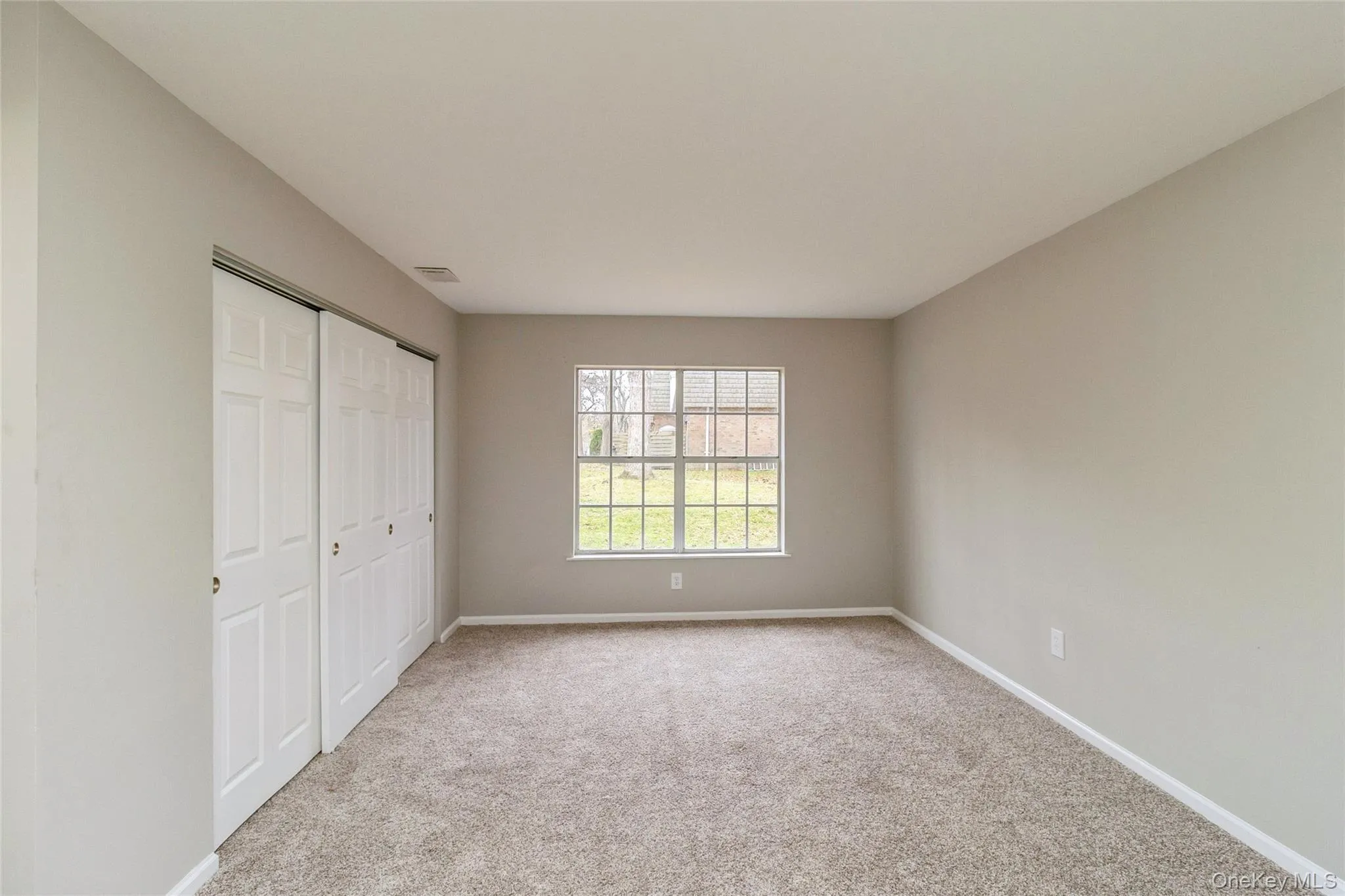 Unfurnished bedroom featuring a closet and light carpet Unfurnished bedroom featuring a closet and light carpet
