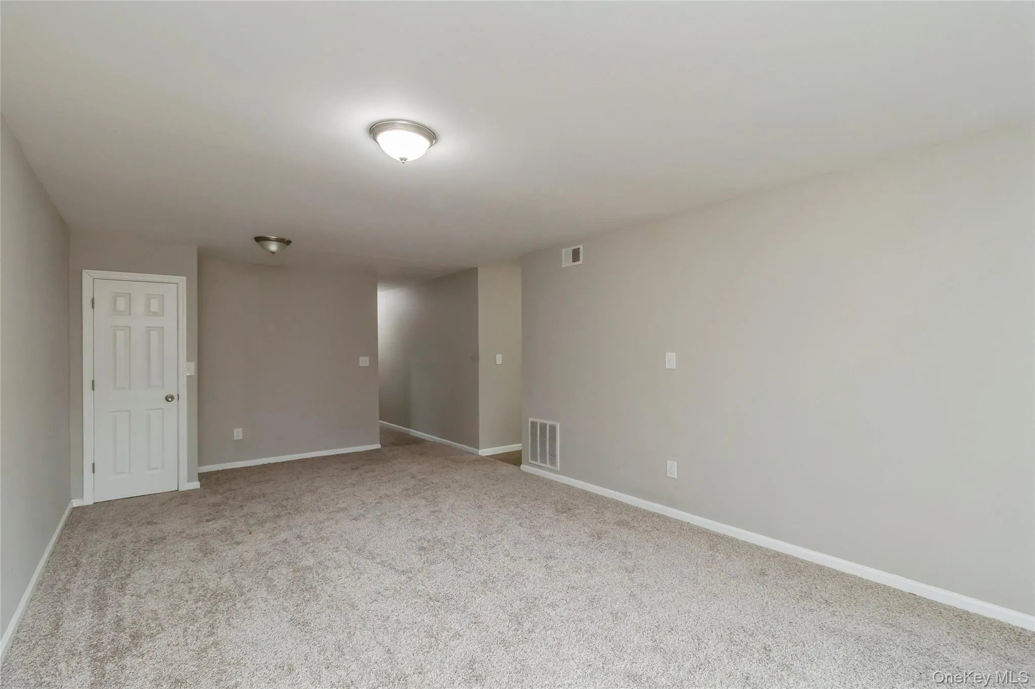 Unfurnished room featuring light carpet and baseboards Unfurnished room featuring light carpet and baseboards