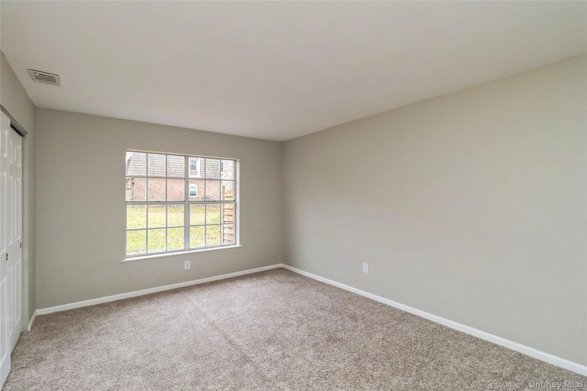 Unfurnished bedroom featuring a closet and light colored carpet Unfurnished bedroom featuring a closet and light colored carpet
