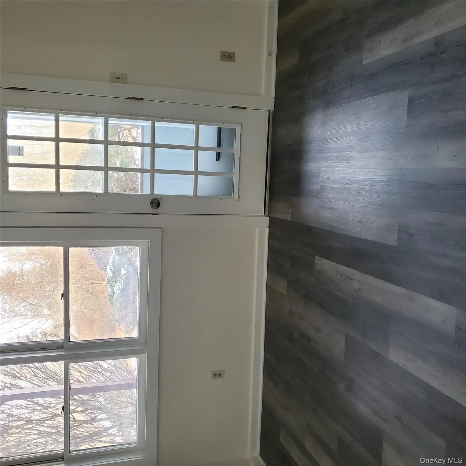 Unfurnished dining area featuring dark wood-type flooring and baseboards Unfurnished dining area featuring dark wood-type flooring and baseboards