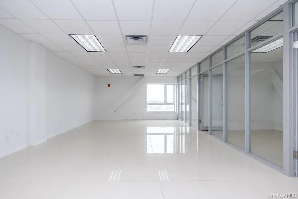 Spare room featuring a paneled ceiling and light tile patterned floors Spare room featuring a paneled ceiling and light tile patterned floors