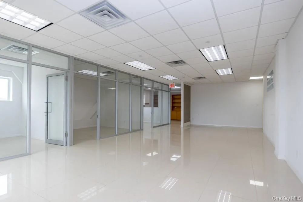 Unfurnished room featuring a drop ceiling and light tile patterned flooring Unfurnished room featuring a drop ceiling and light tile patterned flooring