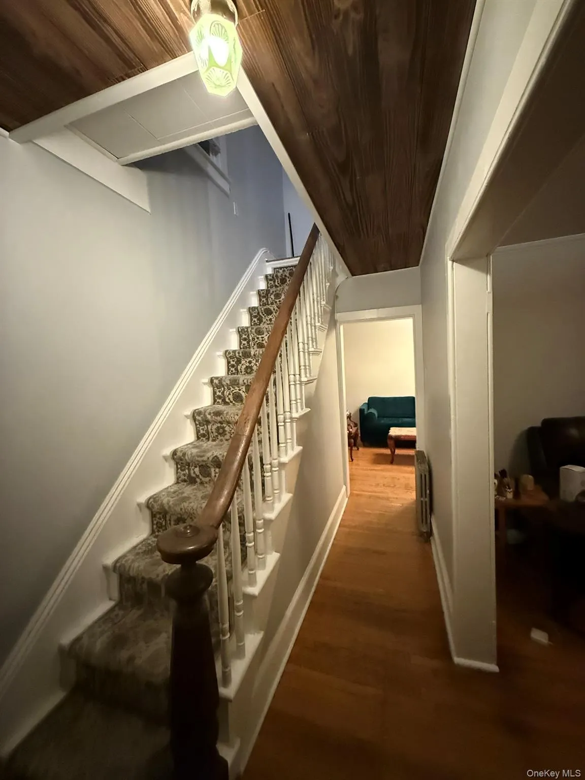 Staircase featuring wood ceiling and wood finished floors Staircase featuring wood ceiling and wood finished floors