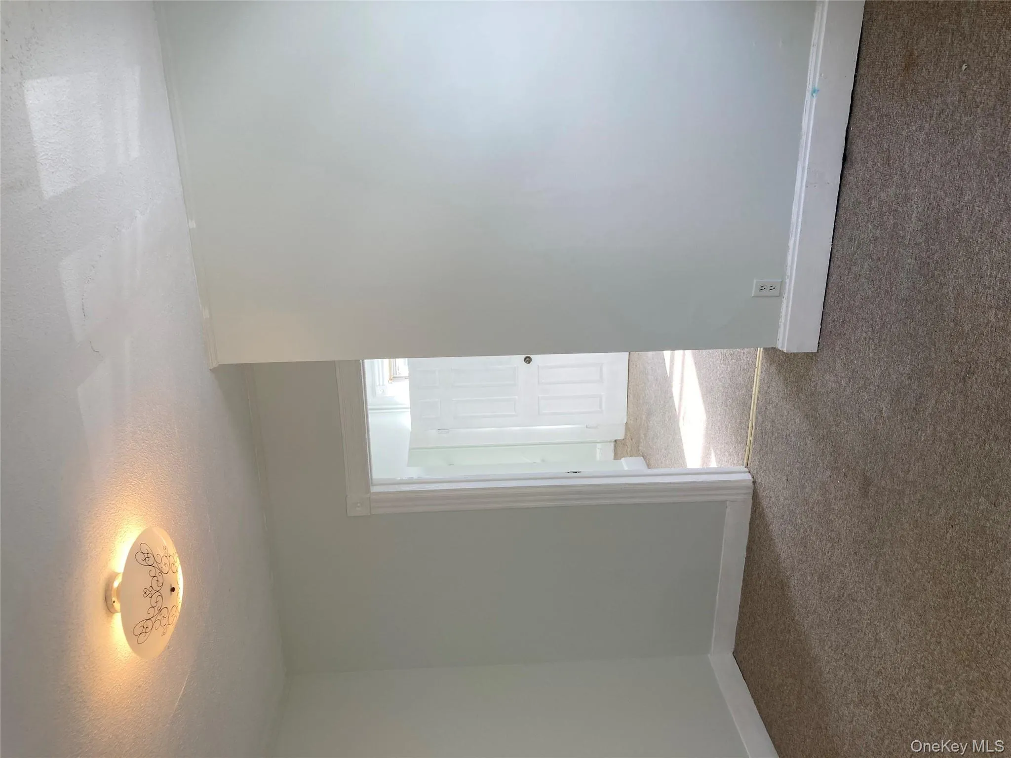 Living room featuring a textured ceiling and carpet floors Living room featuring a textured ceiling and carpet floors