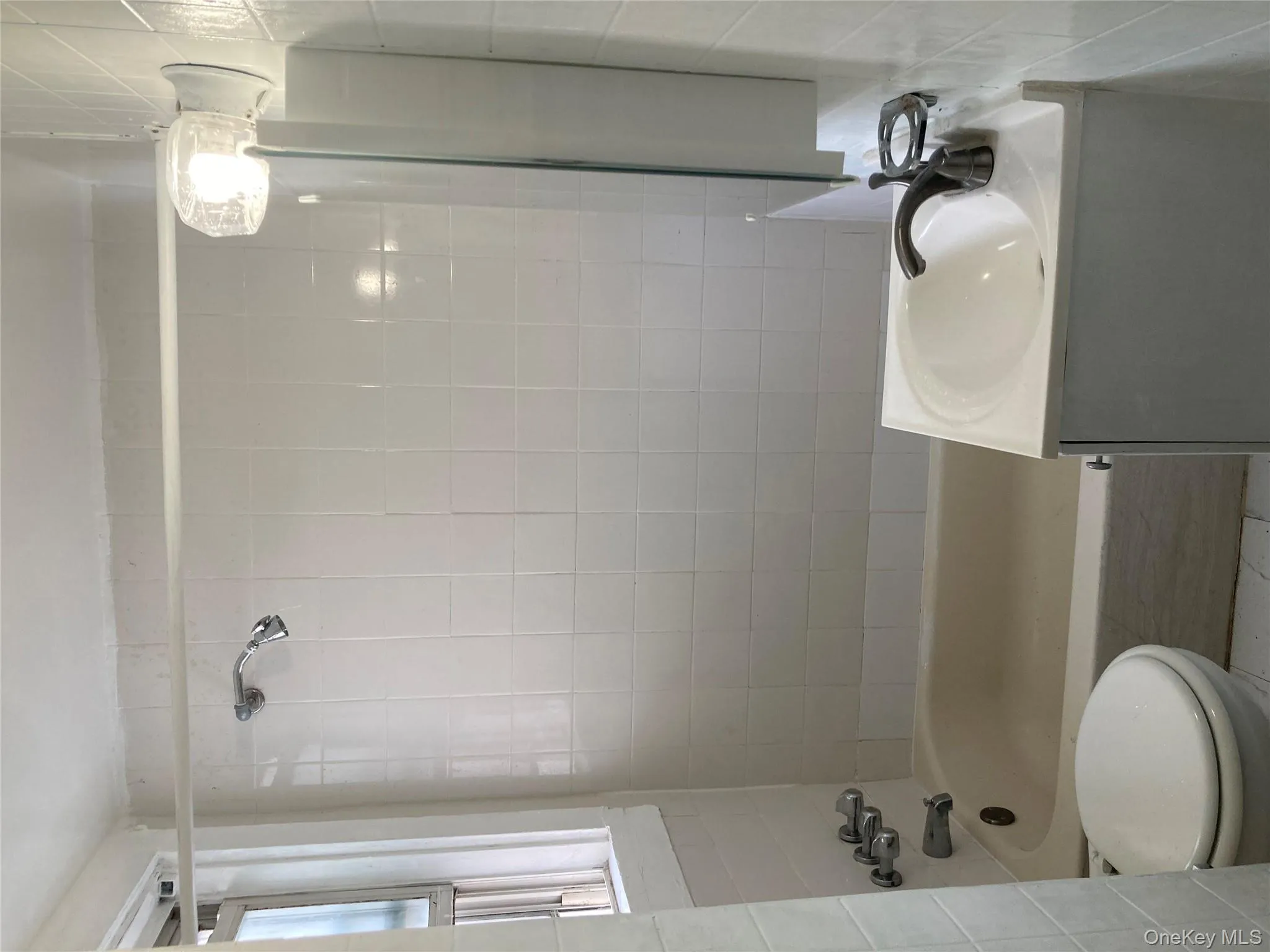 Full bath with shower / washtub combination, vanity, and tile walls Full bath with shower / washtub combination, vanity, and tile walls