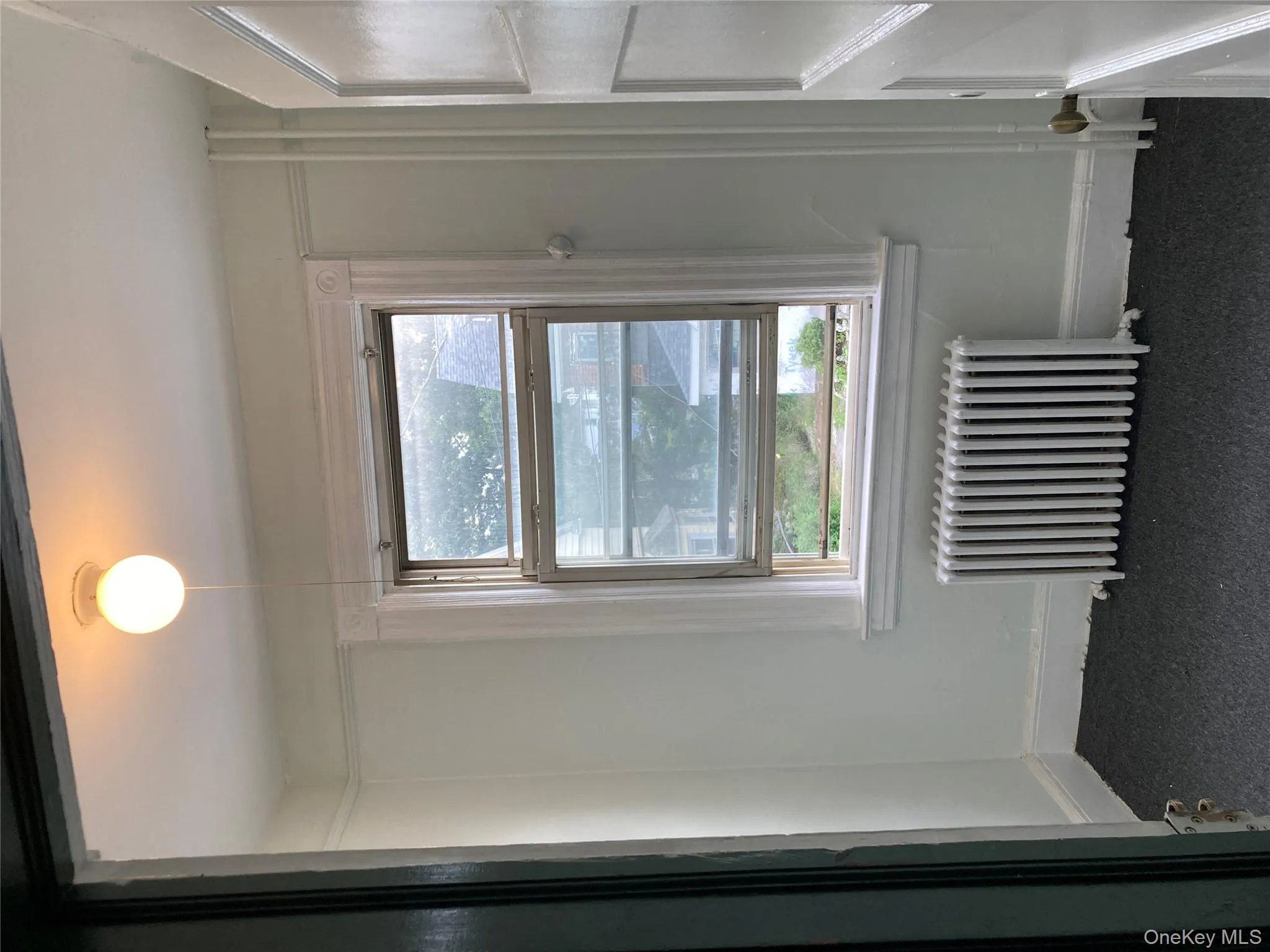 Unfurnished Bonus/ Office room with radiator heating unit and dark colored carpet Unfurnished Bonus/ Office room with radiator heating unit and dark colored carpet